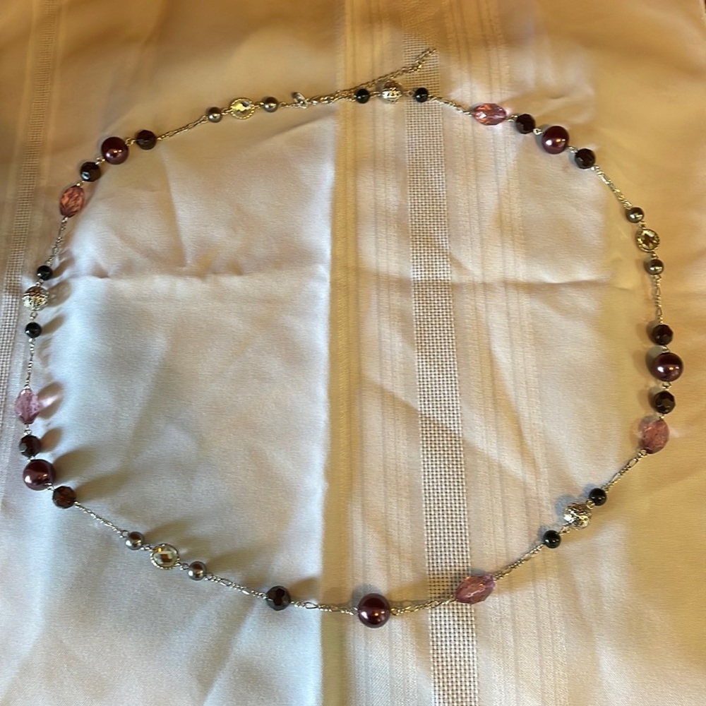 Lia Sophia necklace. Multiple shades of purple. Hangs 18 inches.